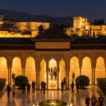 Alhambra palace illuminated at night showing tourist attendance during evening tours